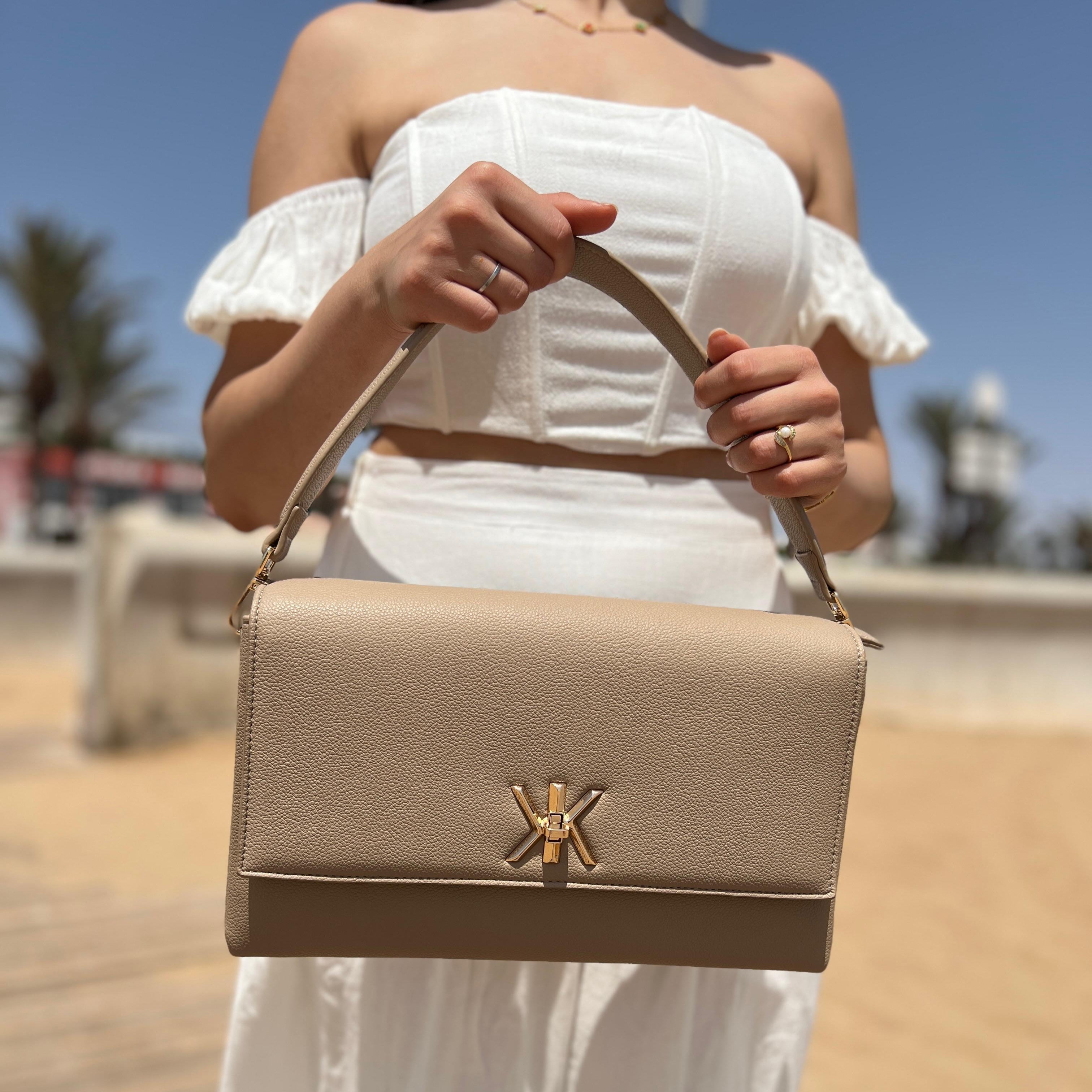 Pochette noire avec anse et bandoulière décorée de détails dorés